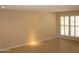 Bright living room with a large window, neutral walls, and easy-to-clean tile floors at 17019 N Pinion Ln, Sun City, AZ 85373