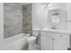 Updated bathroom with tub, modern vanity, and neutral tile surround at 1730 W Pershing Ave, Phoenix, AZ 85029