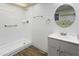 Clean bathroom features a walk-in shower, white vanity, and a round mirror at 1730 W Pershing Ave, Phoenix, AZ 85029