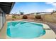 Backyard view of a sparkling blue pool surrounded by desert landscaping at 1730 W Pershing Ave, Phoenix, AZ 85029