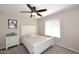 A cozy bedroom with neutral tones, a white bed frame, a ceiling fan, and soft carpet at 1920 E Manzanita Dr, Phoenix, AZ 85020