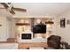 Stylish living room with built-in shelving, a fireplace, hardwood floors, and comfortable seating for relaxation at 1920 E Manzanita Dr, Phoenix, AZ 85020