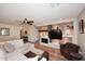 Cozy living room featuring a modern fireplace, built-in shelving, hardwood floors, and comfortable seating at 1920 E Manzanita Dr, Phoenix, AZ 85020