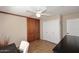 Cozy office featuring tile flooring, a ceiling fan, and wood sliding doors with a closet for storage at 1920 E Manzanita Dr, Phoenix, AZ 85020