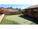 This putting green has a manicured artificial surface, mature landscaping, and mountain views at 1920 E Manzanita Dr, Phoenix, AZ 85020