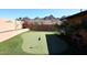 This beautiful putting green features an artificial surface, mountain views, and mature landscaping at 1920 E Manzanita Dr, Phoenix, AZ 85020