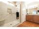 Bathroom with a glass shower, white marble tile surround, hexagon tile floor, and wooden vanity at 19217 N Casa Blanca Way, Surprise, AZ 85387