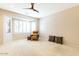 Spacious bedroom with neutral carpet, a ceiling fan, plantation shutters and plenty of natural light at 19217 N Casa Blanca Way, Surprise, AZ 85387