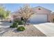 A single-story residence with a two-car garage, desert landscaping and a well-maintained lawn at 19217 N Casa Blanca Way, Surprise, AZ 85387