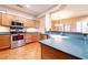 Kitchen featuring stainless steel appliances, custom cabinets, and tile flooring at 19217 N Casa Blanca Way, Surprise, AZ 85387