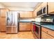 Well-equipped kitchen with stainless steel appliances, ample cabinet space, and tile flooring at 19217 N Casa Blanca Way, Surprise, AZ 85387