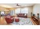 Inviting living room with tile floors, comfortable seating, and a ceiling fan at 19217 N Casa Blanca Way, Surprise, AZ 85387