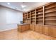 Office with tile flooring, large built-in wood shelves and cabinets, and a window with plantation shutters at 19217 N Casa Blanca Way, Surprise, AZ 85387