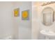 A clean powder room features a white sink, a decorative mirror, and a pair of flower canvas art for a modern touch at 1998 S Starling Dr, Gilbert, AZ 85295