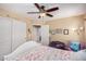 Cozy bedroom with closet, chair, and decorations, with tan carpet and walls at 1998 S Starling Dr, Gilbert, AZ 85295