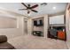 Neutral bedroom featuring built-in cabinets above a wooden desk, a TV set, and a dark ceiling fan at 1998 S Starling Dr, Gilbert, AZ 85295