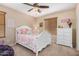 Cozy bedroom with white wood bed frame and a four-drawer dresser, with tan carpet and walls at 1998 S Starling Dr, Gilbert, AZ 85295