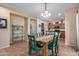 An open dining area features a wood table with green chairs and view into the kitchen, providing a welcoming space at 1998 S Starling Dr, Gilbert, AZ 85295