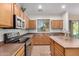 The spacious kitchen features stainless steel appliances, dark countertops, and wooden cabinets for a modern feel at 1998 S Starling Dr, Gilbert, AZ 85295