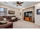 Inviting living room with comfortable sofa, modern ceiling fan, and a large TV, ideal for Gathering gatherings at 1998 S Starling Dr, Gilbert, AZ 85295