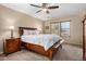 Bright main bedroom showcasing a large wooden bed frame, plush carpet and two large windows at 1998 S Starling Dr, Gilbert, AZ 85295