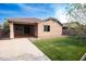 Backyard featuring a covered patio and artificial grass landscaping at 20471 E Carriage Way, Queen Creek, AZ 85142