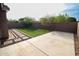 Backyard featuring artificial grass, a patio, and brick trimmed landscaping at 20471 E Carriage Way, Queen Creek, AZ 85142