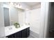 Bathroom featuring a double sink vanity and shower-tub combo at 20471 E Carriage Way, Queen Creek, AZ 85142