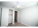 Bright bedroom with ceiling fan and closet with sliding doors at 20471 E Carriage Way, Queen Creek, AZ 85142