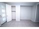 Stylish bedroom features a modern door design, neutral gray walls, and tiled flooring at 20471 E Carriage Way, Queen Creek, AZ 85142