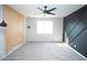 Spacious bedroom featuring wood accent walls, plush carpet and a ceiling fan at 20471 E Carriage Way, Queen Creek, AZ 85142