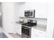 Bright kitchen featuring stainless steel appliances, granite countertops, and white cabinetry at 20471 E Carriage Way, Queen Creek, AZ 85142
