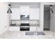 Well-lit kitchen with white cabinets, stainless steel appliances and speckled granite countertops at 20471 E Carriage Way, Queen Creek, AZ 85142