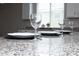 Close-up of a modern kitchen featuring granite countertops and sleek dining ware at 20471 E Carriage Way, Queen Creek, AZ 85142