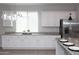 Bright, white kitchen boasting modern cabinets, granite countertops, and stainless steel appliances at 20471 E Carriage Way, Queen Creek, AZ 85142