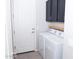 Well-organized laundry area features modern washer/dryer, stylish door and functional cabinets at 20471 E Carriage Way, Queen Creek, AZ 85142
