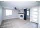 Spacious living room with a cozy fireplace, modern sliding barn door, and tiled entry at 20471 E Carriage Way, Queen Creek, AZ 85142