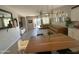 Inviting living room with a leather sectional, modern lighting, and sliding glass doors to the backyard at 20471 E Carriage Way, Queen Creek, AZ 85142