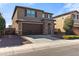 Two-story home with a two car garage, stone accents, and a well-maintained front lawn at 21195 W Coronado Rd, Buckeye, AZ 85396