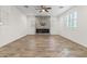 Living room featuring a modern fireplace, neutral tones, and ample natural light at 21195 W Coronado Rd, Buckeye, AZ 85396