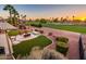 Aerial view of backyard showcasing a putting green, water feature, fire pit, and golf course at 22020 N San Ramon Dr, Sun City West, AZ 85375