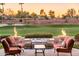 Outdoor seating area with fire bowls and water feature overlooking a beautiful golf course at 22020 N San Ramon Dr, Sun City West, AZ 85375