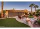 Outdoor patio with retractable screen, fire features, seating area, putting green and lush landscaping at 22020 N San Ramon Dr, Sun City West, AZ 85375