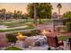 Serene outdoor seating area with fire bowls, water feature and view of a beautiful golf course at 22020 N San Ramon Dr, Sun City West, AZ 85375