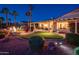 Night view of backyard featuring a putting green, fire pit, and mature landscaping at 22020 N San Ramon Dr, Sun City West, AZ 85375