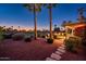 Scenic backyard view with palm trees, putting green, fire pit, and views of the golf course at 22020 N San Ramon Dr, Sun City West, AZ 85375