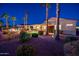 This desert backyard features a patio, firepit, putting green, and mature trees at 22020 N San Ramon Dr, Sun City West, AZ 85375