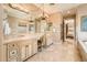 Large bathroom with dual sinks, granite counters, and a relaxing spa tub at 22020 N San Ramon Dr, Sun City West, AZ 85375