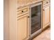 Close-up of cabinets with granite countertop and stainless steel beverage cooler at 22020 N San Ramon Dr, Sun City West, AZ 85375