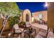 Private courtyard with comfortable seating, lush landscaping and an arched entry at 22020 N San Ramon Dr, Sun City West, AZ 85375